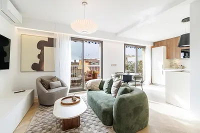 a living room with a couch and a table at Appartement Mamabaldi in Nice