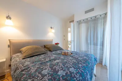 a bedroom with a bed with a tray on it at flora in Beaulieu-sur-Mer