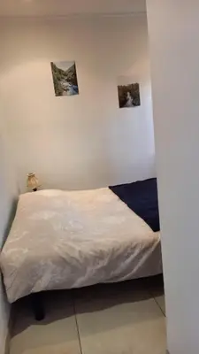 a bed in a room with three pictures on the wall at Villa Cornetti in Nice