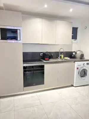 a kitchen with a sink and a washing machine at T4 Front de mer Piscine interieure privee Clim in Cagnes-sur-Mer