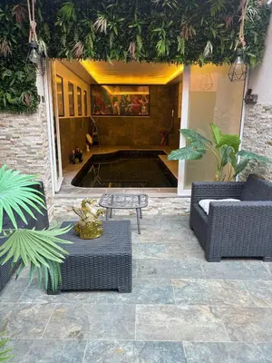 a patio with two couches and a table in a building at T4 Front de mer Piscine interieure privee Clim in Cagnes-sur-Mer