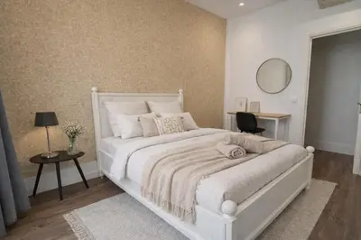 a bedroom with a white bed and a mirror at RAIMBALDI Urban Gare - Spacieux T3 climatisé au cœur du centre-ville in Nice