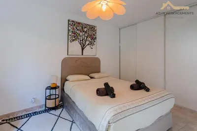 a bedroom with a bed with two bags on it at Nice 2 pièces proche centre in Nice