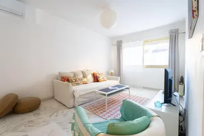 a living room with a couch and a tv at Rue Michelet in Nice