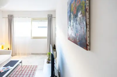 a living room with a painting on the wall at Rue Michelet in Nice
