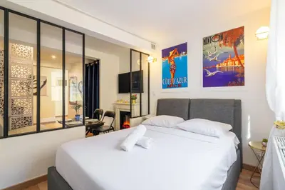 a bedroom with a large white bed in a room at 9 rue Pairoliere in Nice