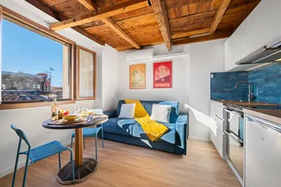 a living room with a blue couch and a table at Le Panoramique - Vieux-Nice in Nice
