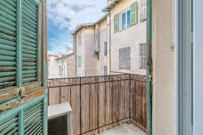 an open window of a building with a fence at Large 2 Bdr City Center close to Train Station in Nice