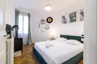 a bedroom with a large white bed and a window at Large 2 Bdr City Center close to Train Station in Nice
