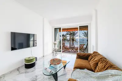 a living room with a couch and a glass table at PROM 92 - Amazing Sea View 3 rooms with terrace in Nice