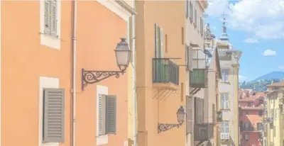 a couple of buildings with balconies and a street light at Small Duplex - Downtown - Close to Beaches in Nice