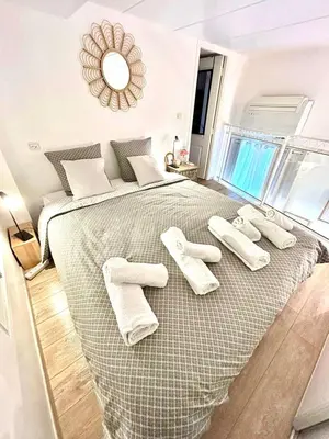 a bedroom with a large bed with white pillows at Small Duplex - Downtown - Close to Beaches in Nice