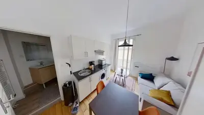 a kitchen with a couch and a table in a room at Appartement Nice Libération in Nice