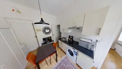 a small kitchen with a table and a microwave at Appartement Nice Libération in Nice