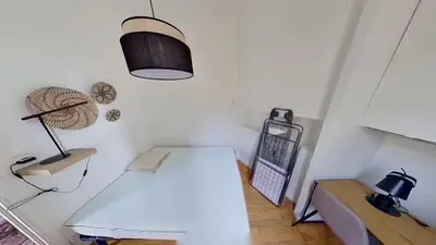 a white room with a table and a lamp at Appartement Nice Libération in Nice