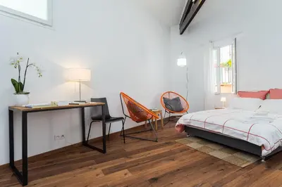 a bedroom with a bed and a desk and a desk at loft proche port Nice in Nice