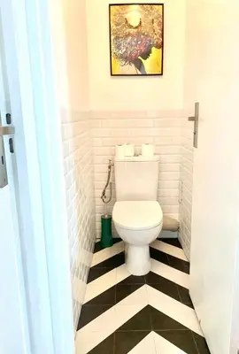 a bathroom with a toilet and a black and white checkered floor at Vue Mer Panoramique - Terrasse - Climatisation - 2 Bedrooms - Wifi - Cuisine - Tramway in Nice