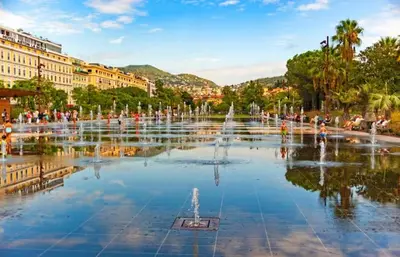 a fountain in a city with people sitting around it at Vue Mer Panoramique - Terrasse - Climatisation - 2 Bedrooms - Wifi - Cuisine - Tramway in Nice