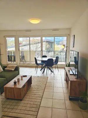 a kitchen with green cabinets and a stainless steel refrigerator at Appartement lumineux avec terrasse à Nice in Nice
