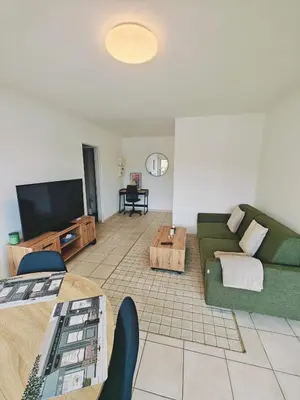a living room with a couch and a table at Appartement lumineux avec terrasse à Nice in Nice