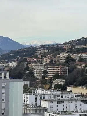 a view of a city with buildings and mountains at Deux pièces moderne avec balcon & Vue dégagée in Nice