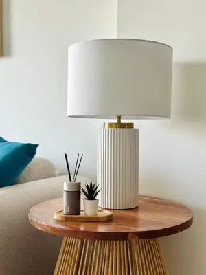 a table with a lamp on top of a couch at Luxury Beachfront 2BR Promenade des Anglais in Nice
