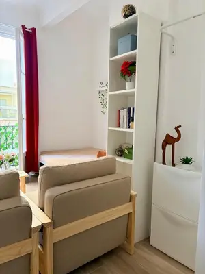 a room with two chairs and a bed in it at Studio avec balcon - Centre-ville & plage à 2 min in Nice