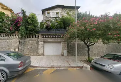 two cars parked in front of a house with a garage at NiceVueEnsoleille in Nice