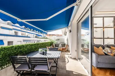 a patio with a table and chairs on a balcony at Super flat in Carré d'Or - 1 minute from the sea in Nice