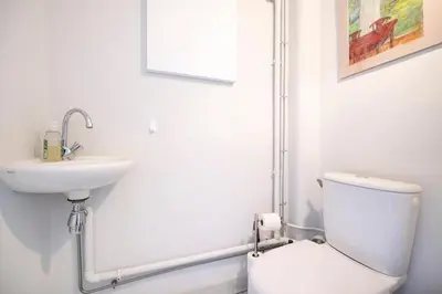 a white bathroom with a toilet and a sink at Azur Balcony Apartment Classic Charm with View in Nice