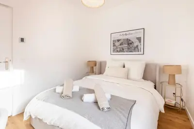 a white bedroom with a bed with two pillows at Appartement Assalit Two bedrooms in Nice in Nice