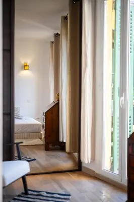 a room with a bedroom with a bed and a window at L'Essentiel Confort - Solaire, Plage, Vieux Nice - by Studio Y in Nice
