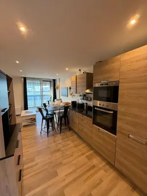 a kitchen with a table and a dining room at Air-conditioned studio comfort & cozy in Saint-Laurent-du-Var