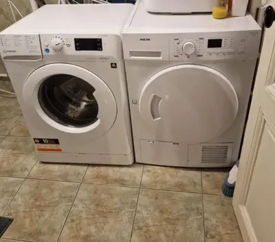a white washing machine sitting next to a washer at très grande chambre climatisée plein centre Nice avec balcon in Nice