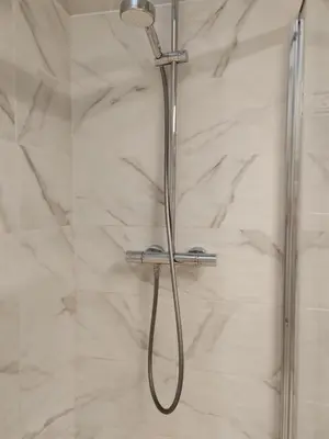 a shower with a shower head in a bathroom at très grande chambre climatisée plein centre Nice avec balcon in Nice
