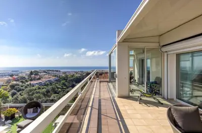 a balcony of a house with a view of the ocean at Penthouse - Vue mer panoramique - SPA privé - Piscine commune in Saint-Laurent-du-Var