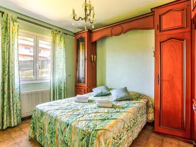 a bedroom with a bed and a chandelier at Holiday Home Maison Valensole by Interhome in Cagnes-sur-Mer