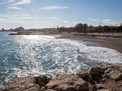 a beach with rocks in the water and the ocean at Holiday Home Maison Valensole by Interhome in Cagnes-sur-Mer