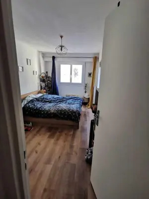 a bedroom with a bed and a window at Charmant 2 pièces in Nice