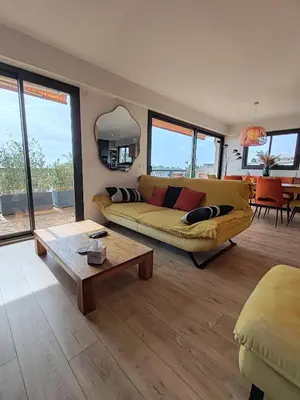 a bedroom with a bed and a large window at Entre mer et montagne - Rooftop panoramique in Saint-Laurent-du-Var