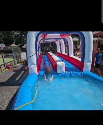 a child playing in a water slide at a water park at Mobilhome Camping 4 étoiles in Cagnes-sur-Mer