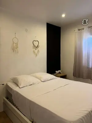 a bedroom with a bed with white sheets and a window at 3 Pièces avec Terrasse sans vis à vis in Nice
