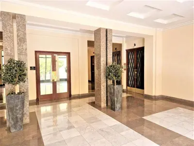 a lobby with two pillars with plants in them at Cœur de Nice à 350m de la mer in Nice