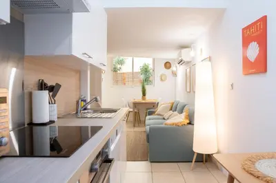 a kitchen and living room with a couch and a table at Duplex carré d'or au calme sur cour 100m de la plage in Nice