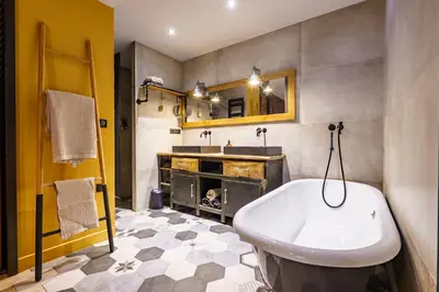 a bathroom with a white tub and a sink at Loft proche du port de Nice - 6 pers - Parking in Nice