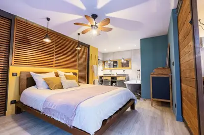 a bedroom with a large bed with a ceiling fan at Loft proche du port de Nice - 6 pers - Parking in Nice