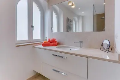 a white bathroom with a sink and a mirror at VILLA ANGEL VI4481 By Riviera Holiday Homes in Èze