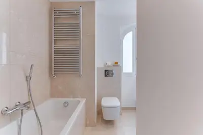 a bedroom with a bed and a flat screen tv at VILLA ANGEL VI4481 By Riviera Holiday Homes in Èze