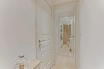 a hallway with a white door and a bathroom at VILLA ANGEL VI4481 By Riviera Holiday Homes in Èze