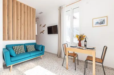 a living room with a blue couch and a table at La Maison Du Pêcheur in Cagnes-sur-Mer
